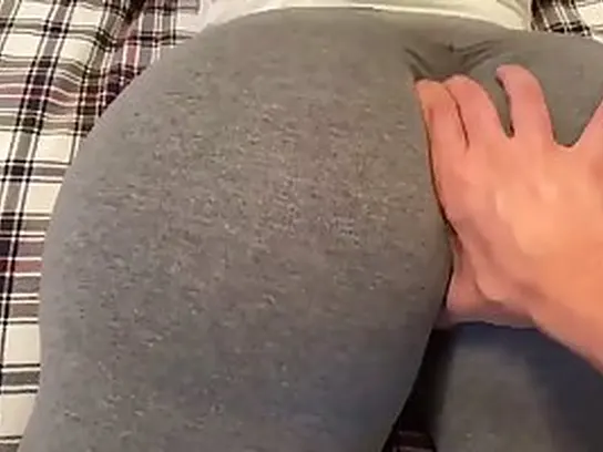 Phat donk brown-haired in yoga trousers is providing a sensuous footjob to one of her pals